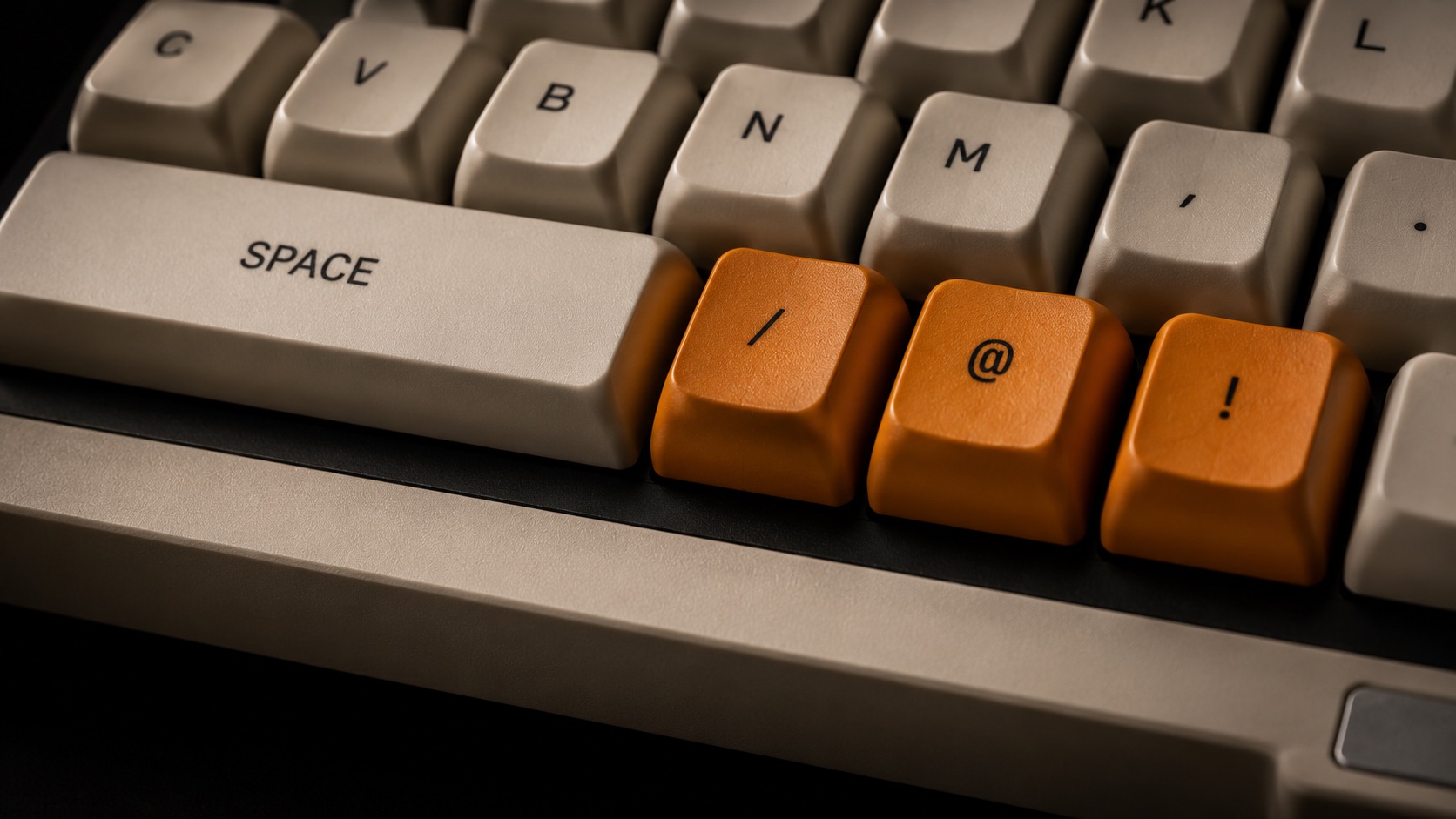 PocketPunk verb dock — SPACE bar with orange slash, at, and bang keys